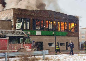 fireman arriving at a store building on fire