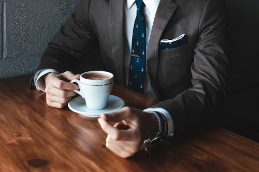 A negotiator drinking a cup of coffee