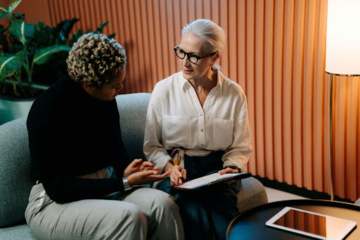 A public adjuster and policyholder reviewing an insurance claim.