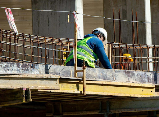 Worker repairing a building, representing post-fire repairs and restoration efforts.