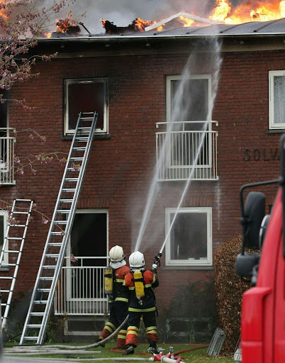 Firefighters battling a fire, symbolizing the immediate response to fire damage.