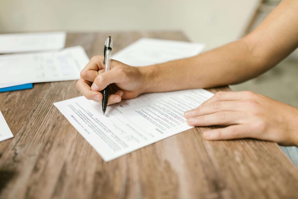 A woman filing out an insurance claim form.