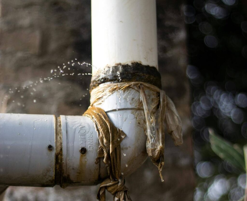 A PVC pipe leak highlighting a common source of water damage in homes.