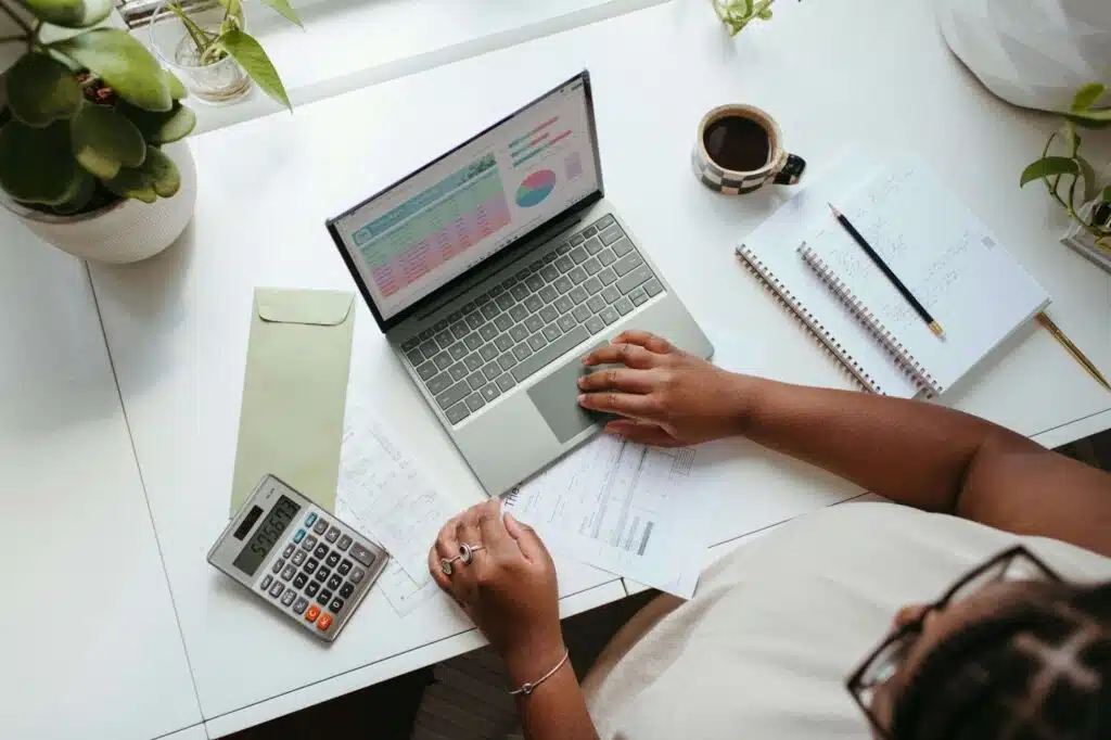 Small business owner reviewing finances and insurance details on a laptop.