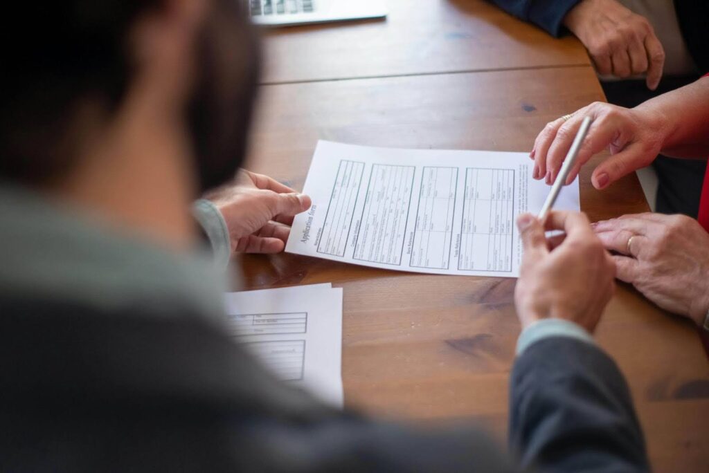 Business partners reviewing insurance paperwork during a consultation.