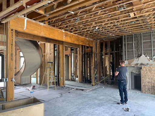 The home under renovation, with structural repairs underway, demonstrating the restoration efforts after securing a successful $1.7 million insurance payout.