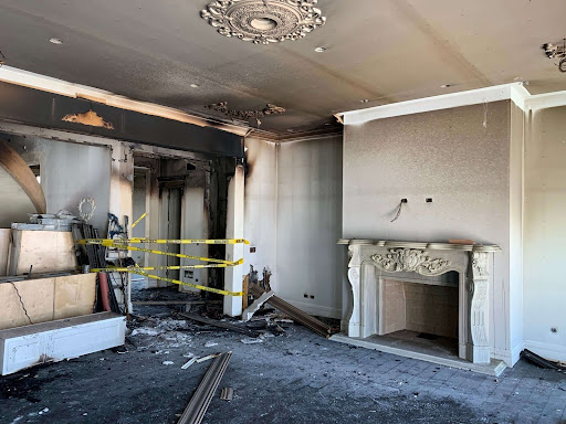 Severe fire damage seen inside the home, highlighting the destruction to walls, ceilings, and decor, which played a critical role in the insurance claim process.