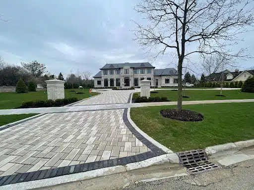 A pristine, upscale home with a large driveway and manicured lawn, setting the stage for an insurance claim worth $1.7 million after extensive interior damage.