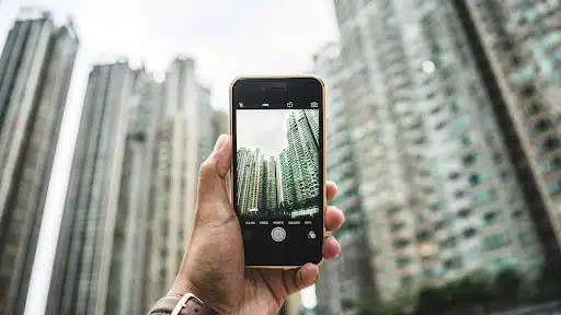 Taking a photo of high-rise buildings before filing a collapse insurance claim.