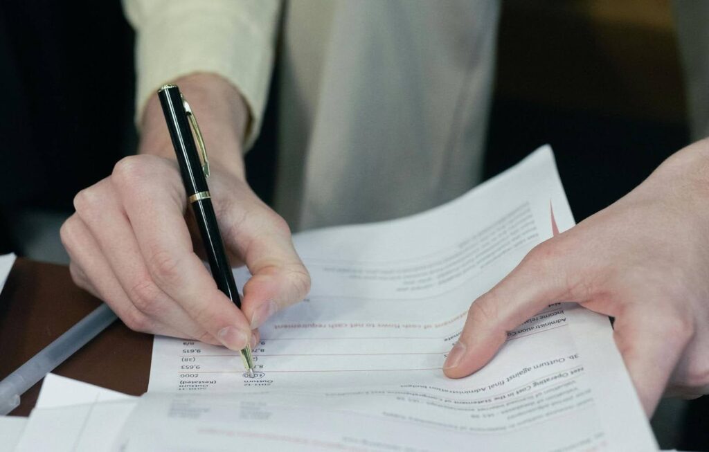 A man filling out an insurance claim form.