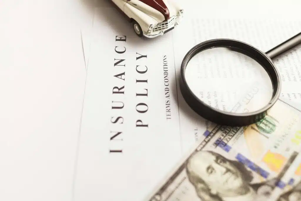 A magnifying glass placed on an insurance policy.